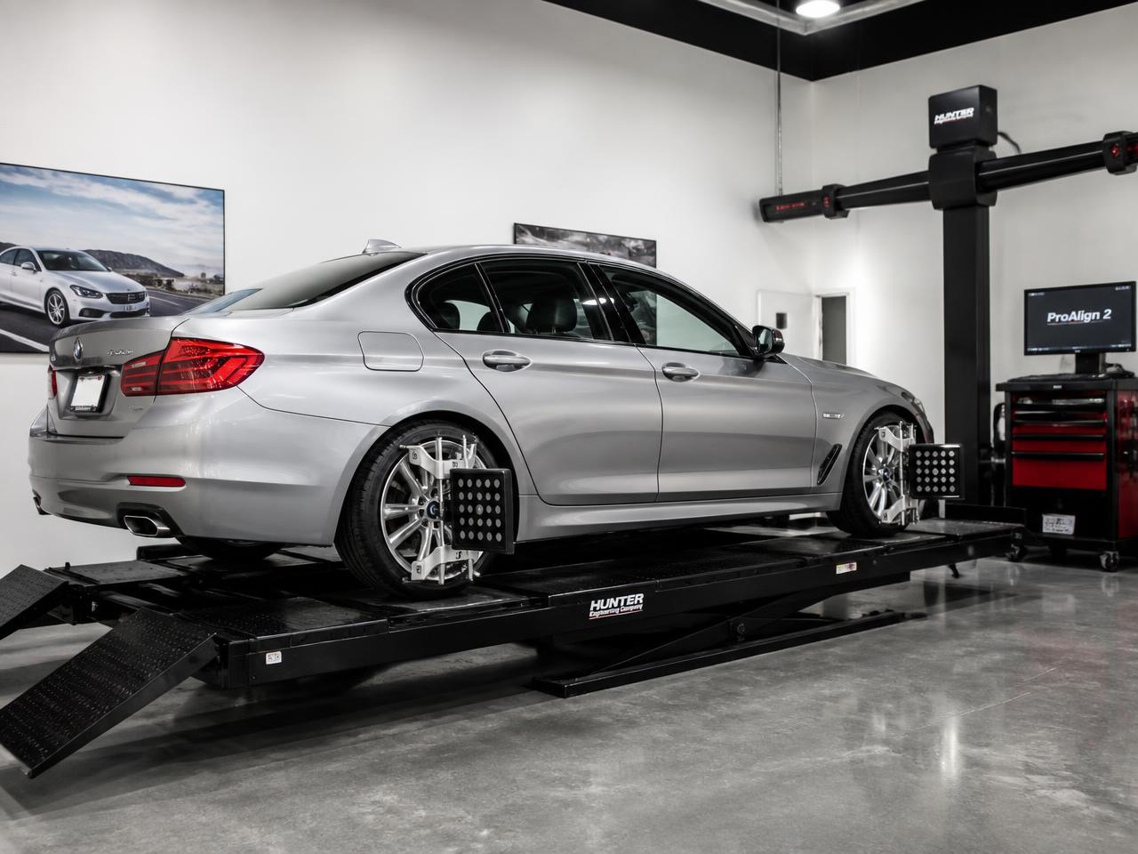 BMW sedan on a Hunter four-wheel alignment rack with matching tires