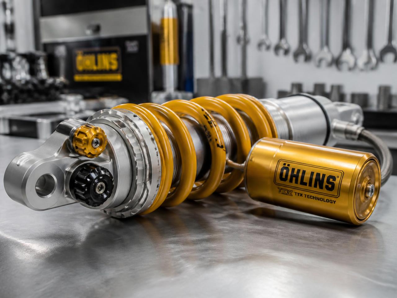 Öhlins gold coilover damper assembly on a workshop bench